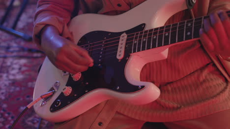 Close-Up-Of-An-Unrecognizable-Musician-Playing-Electric-Guitar-In-Recording-Studio