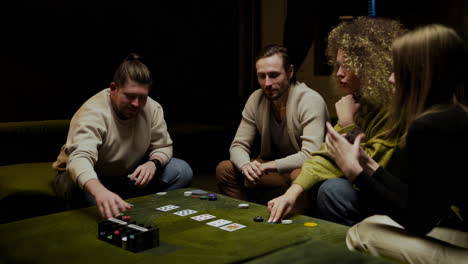 Group-Of-Friends-Playing-Poker-Sitting-On-The-Couch-In-The-Living-Room-5