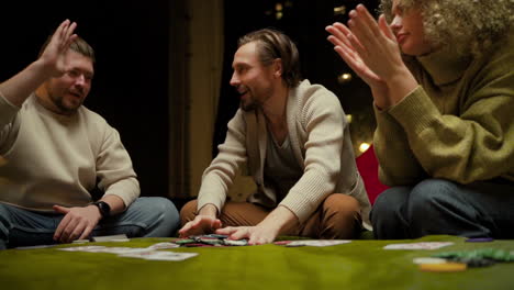 Bottom-View-Of-Group-Of-Friends-Playing-Poker