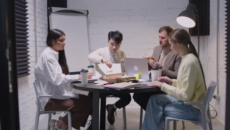 Gruppe-Multiethnischer-Kollegen,-Die-Während-Einer-Teambesprechung-Im-Sitzungssaal-Pizza-Essen