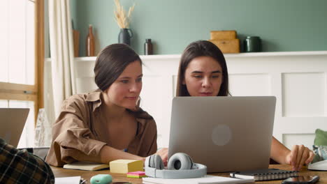 Camera-Focuses-On-Two-Girls-Of-A-Study-Group-Who-Are-Talking-And-Looking-At-Laptop