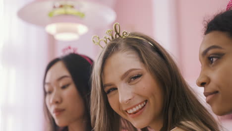 Close-Up-View-Of-Bachelor-Girl-With-Headdress-With-Bride-Word-Surrounded-By-Her-Friends