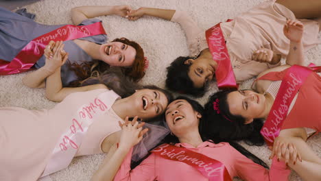 Top-View-Of-Bachelor-Girl-And-Her-Friends-Holding-Hand-Lying-On-The-Carpet-1
