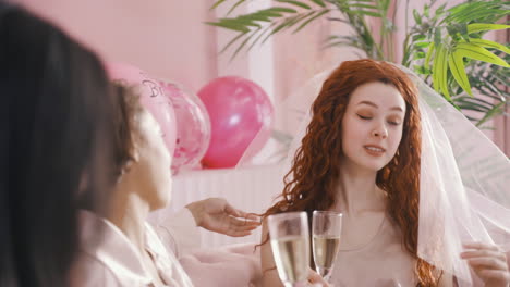 Close-Up-View-Of-Bachelor-Girl-Talking-And-Drinking-Champagne-Sitting-On-Sofa-Celebrating-Bachelorette-Party-With-Her-Friends