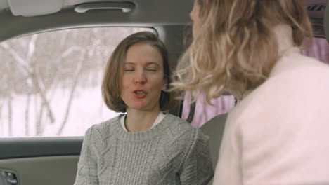 Woman-And-Man-Talking-Together-While-Sitting-In-The-Car-On-Winter-Day