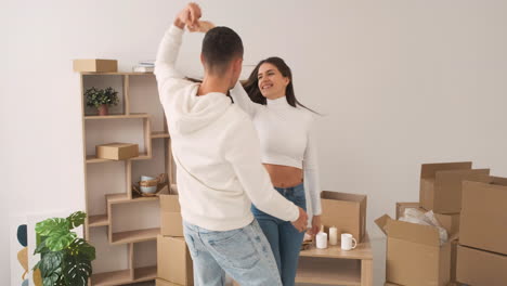 Front-View-Of-A-Young-Happy-Couple-Dancing-Together-In-A-New-House-1