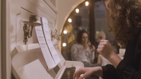 Curly-Woman-Playing-Piano-At-Restaurant-1