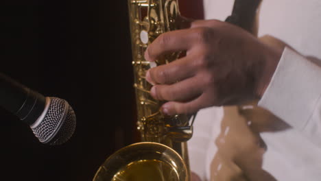 Close-Up-View-Of-Latin-Man's-Hands-Playing-Sax-During-Live-Music-Perfomance