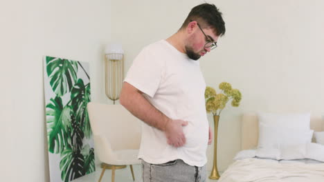 Boy-Grabbing-His-Belly-Fat-In-The-Bedroom-1