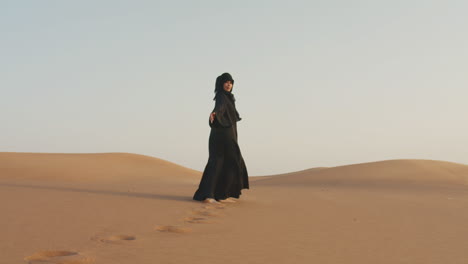 Follow-Me-Shot-Of-A-Beautiful-Muslim-Woman-With-Hijab-Walking-Barefoot-In-A-Windy-Desert