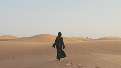 Follow-Me-Shot-Of-A-Beautiful-Muslim-Woman-With-Hijab-Walking-Barefoot-In-A-Windy-Desert-1