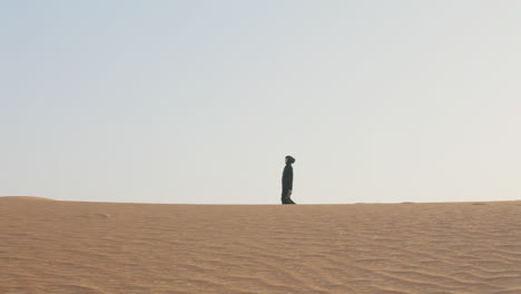 Muslim-Woman-Wearing-Hijab-Walking-In-The-Desert