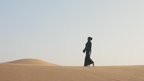 Muslim-Woman-In-Hijab-Walking-Barefoot-In-The-Desert