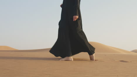 Close-Up-Of-An-Unrecognizable-Muslim-Woman-Walking-Barefoot-In-The-Desert-2