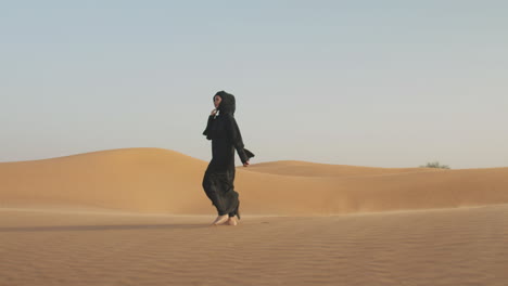 Beautiful-Muslim-Woman-In-Hijab-Walking-Barefoot-In-A-Windy-Desert-2
