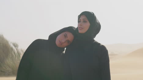 Portrait-Of-Two-Muslim-Women-In-Hijab-Standing-In-A-Windy-Desert-2