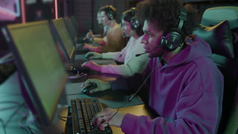 Zoom-In-Shot-Of-A--Team-Of-Cybersport-Gamers-Playing-Video-Games-In-A-Gaming-Club