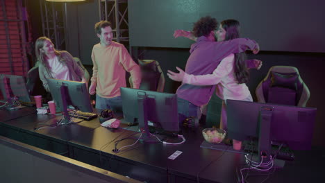 -Team-Of-Professional-Cybersport-Gamers-Celebrating-Success-Hugging-Each-Other-While-Participating-In-Esports-Tournament