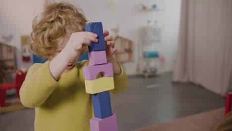 Blond-Little-Boy-Playing-With-Foam-Building-Blocks-In-A-Montessori-School-2