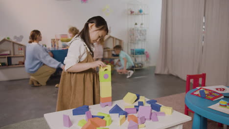 Little-Girl-Playing-With-Foam-Building-Blocks-In-A-Montessori-School