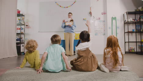 Female-Teacher-Teaching-Words-To-Her-Pupils-In-A-Montessori-School