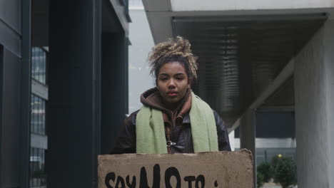 Junger-Amerikanischer-Klimaaktivist,-Der-Ein-Plakat-Hält-Und-Gegen-Die-Einwegplastik-Protestiert,-Während-Er-In-Die-Kamera-1-Blickt