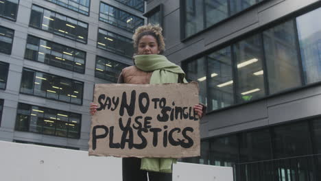 Low-Angle-Shot-Of-A-Young-American-Female-Climate-Activist-Protesting-Against-The-Single-Use-Plastics-While-Looking-At-Camera
