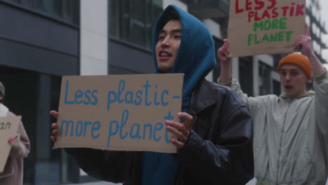 Jóvenes-Activistas-Climáticos-Masculinos-Sosteniendo-Pancartas-Y-Protestando-Contra-El-Uso-De-Plástico