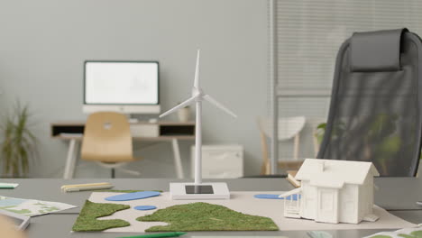 Wind-Turbine-Miniature-And-House-Model-On-Office-Table-1