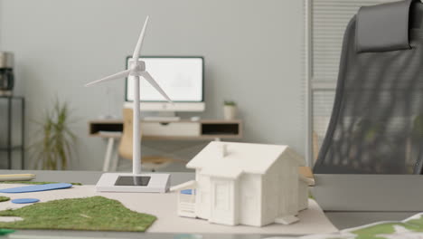 Wind-Turbine-Miniature-And-House-Model-On-Office-Table-2