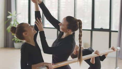 Female-Teacher-Corrects-The-Arm-Position-Of-The-Gymnastic-Girl-In-Ballet-Class