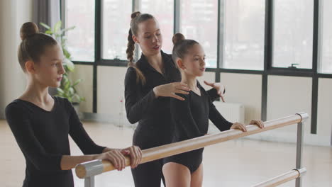 Female-Teacher-Corrects-The-Arms-Position-Of-The-Gymnastic-Girl-In-Ballet-Class-1