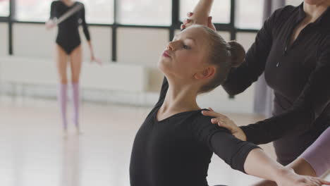 Female-Teacher-Corrects-The-Arm-And-Head-Position-Of-The-Gymnastic-Girl-In-Ballet-Class