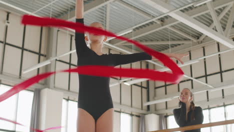 Two-Young-Girls-Practising-Rhythmic-Gymnastics-With-A-Ribbon-While-Female-Teacher-Watching-Them-2