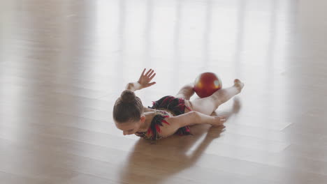 Young-Girl-In-Leotard-Practising-Rhythmic-Gymnastic-With-A-Ball-In-A-Studio-3