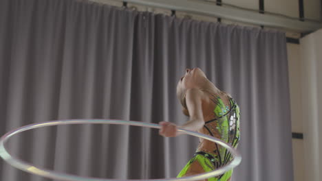 Young-Girl-In-Leotard-Practising-Rhythmic-Gymnastics-With-A-Ring-In-A-Studio-2
