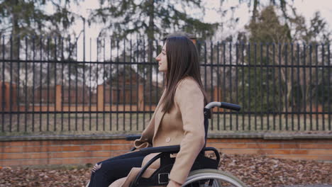 Disabled-Woman-Turning-The-Wheels-Of-Her-Wheelchair-For-A-Ride-Around-The-City-1