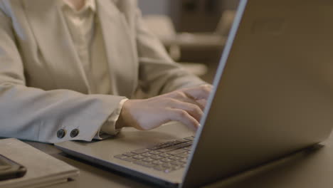Close-Up-Of-Employee-Woman-Hands-Typing-On-Laptop-Keyboard-At-Workplace