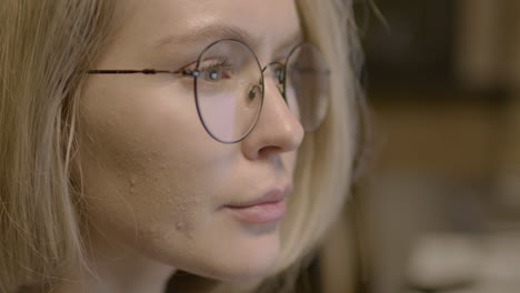 Close-Up-View-Of-Blonde-Woman-Employee-Wearing-Eyeglasses-And-Watching-The-Computer-Monitor-In-The-Office