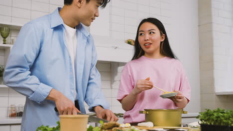 Japanese-Couple-Cooking-Japanese-Food-While-Talking-And-Laughing-In-The-Kitchen-1