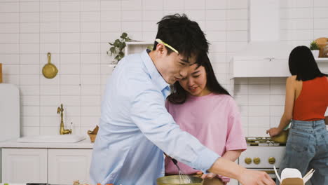 Japanese-Couple-Cooking-Japanese-Food-While-Talking-And-Laughing-In-The-Kitchen-2