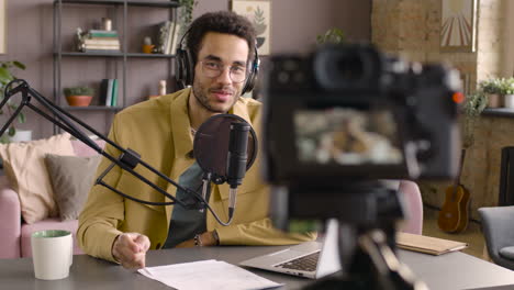 Man-Wearing-Headphones-And-Talking-Into-A-Microphone-1