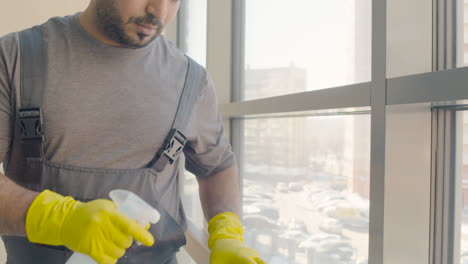 Nahaufnahme-Eines-Arabischen-Putzmannes-Mit-Handschuhen,-Der-Treppengeländer-In-Einem-Bürogebäude-Reinigt