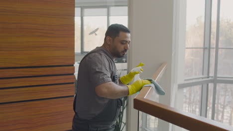 Arabic-Cleaning-Man-Cleaning-Stair-Railing-Inside-An-Office-Building-While-Dancing