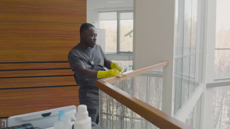 Cleaning-Man-Cleaning-Stair-Railing-Inside-An-Office-Building-While-Dancing