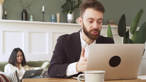 Businessman-Sitting-At-Table,-Having-A-Video-Call-On-Laptop-Computer-1
