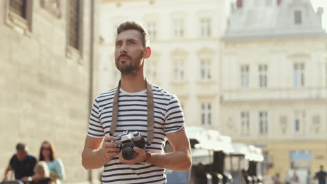 Handsome-Man-Taking-Photos-With-A-Camera-In-The-Old-Town