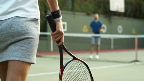 Nahaufnahme-Einer-Nicht-Erkennbaren-Tennisspielerin,-Die-Zum-Netz-Geht-Und-Einen-Männlichen-Co-Spieler-Trifft