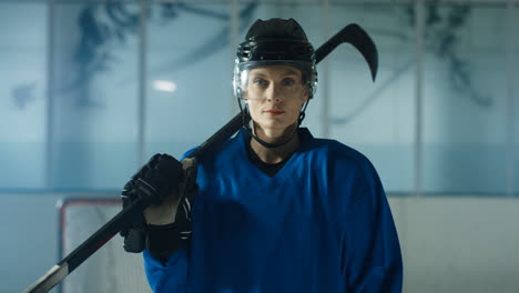 Portrait-Of-A-Happy-Female-Hockey-Player-Looking-Cheerfully-At-The-Camera-On-The-Ice-Arena
