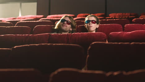 Fernsicht-Auf-Ein-Paar-Mit-3D-Brille,-Das-Im-Kino-Sitzt,-Während-Sie-Einen-Film-Ansehen-Und-Popcorn-Essen